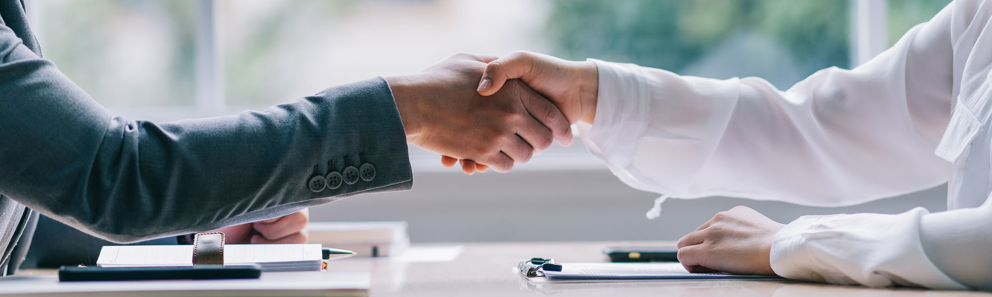 A tenant and New York Landlord-Tenant Lawyer shaking hands