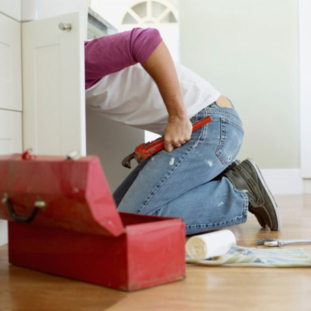 plumber working under sink 1